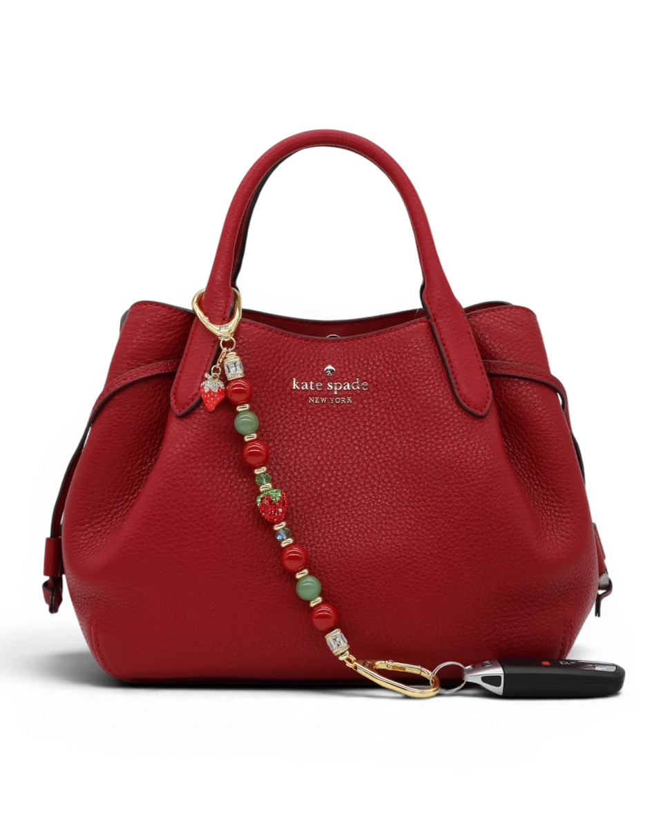 LD Keyfinder Strawberry Fields beaded accessory with red shell pearls, green aventurine, and crystal strawberry charm.