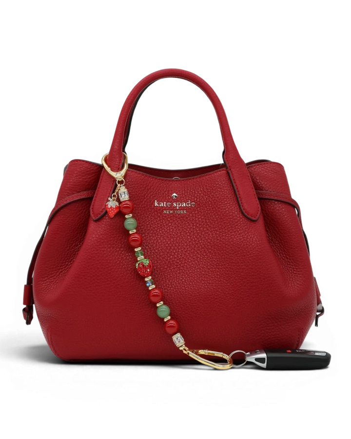 LD Keyfinder Strawberry Fields beaded accessory with red shell pearls, green aventurine, and crystal strawberry charm.