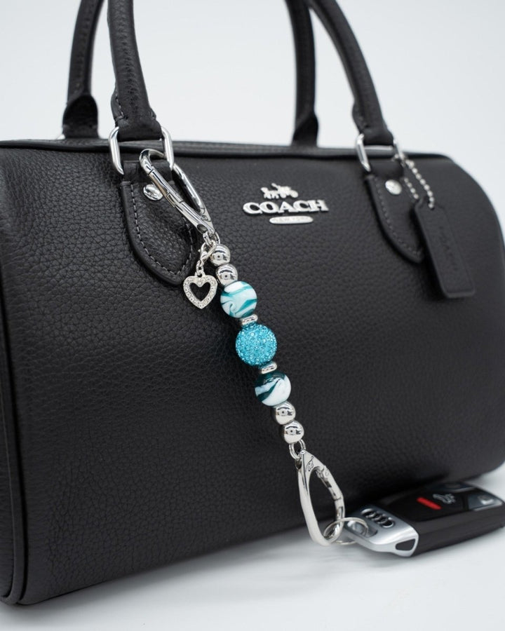 LD Keyfinder Teal My Heart-Mini keychain with teal swirl glass beads, crystal center, and silver heart charm on bag