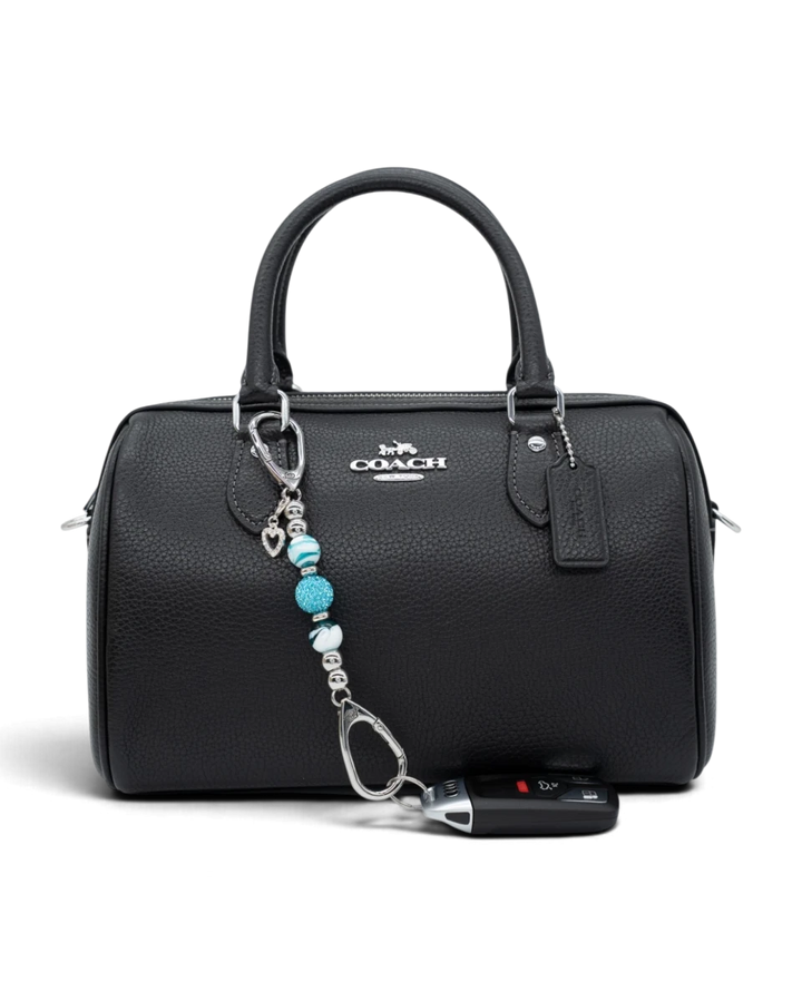 LD Keyfinder Teal My Heart-Mini keychain with teal swirl glass beads and a silver rhinestone heart on a black handbag