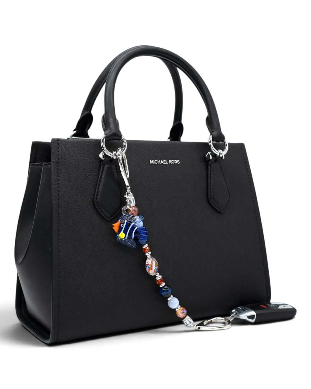 LD Keyfinder Tropical Tango beaded keychain with artisan glass fish charm attached to a black leather handbag