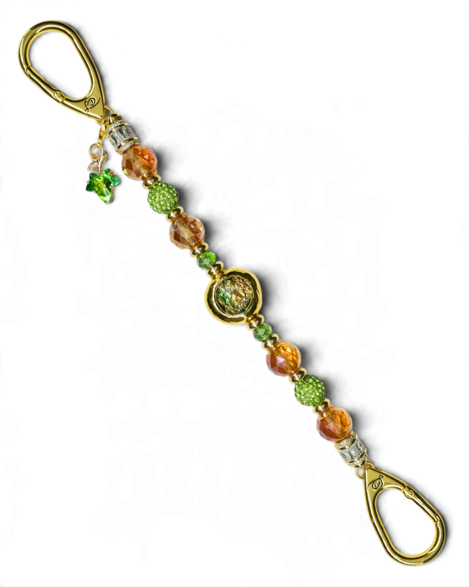 LD Keyfinder Verdant Flame accessory featuring green and burnt orange beads with a gold-plated leaf charm and centerpiece