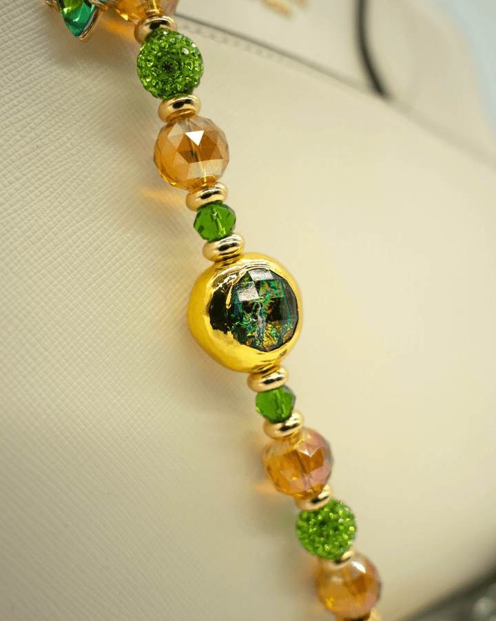 LD Keyfinder Verdant Flame beaded accessory featuring green and orange crystals with a gold-plated resin centerpiece.