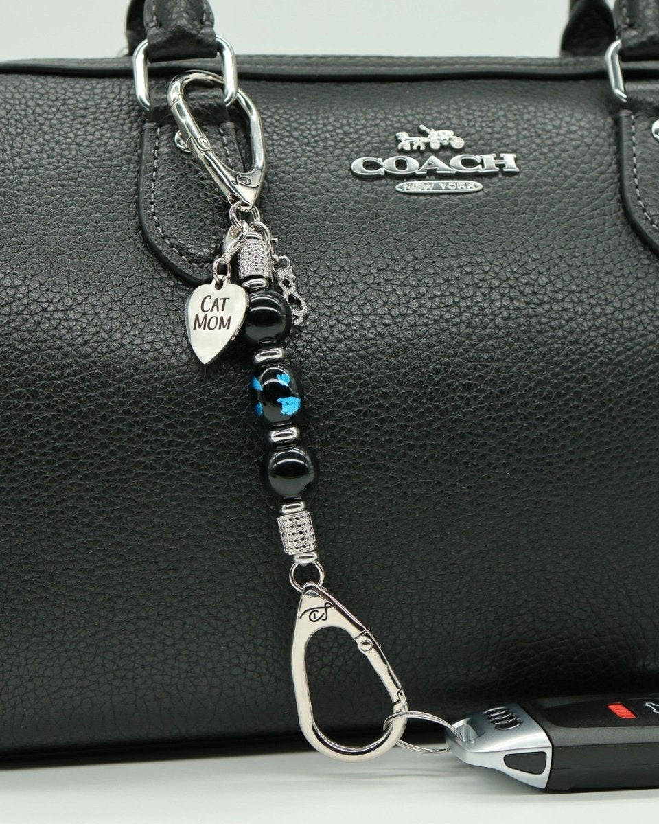 LD Keyfinder Whisker Dreams-Mini featuring black obsidian beads, blue foil cat glass, and Cat Mom charm on a handbag