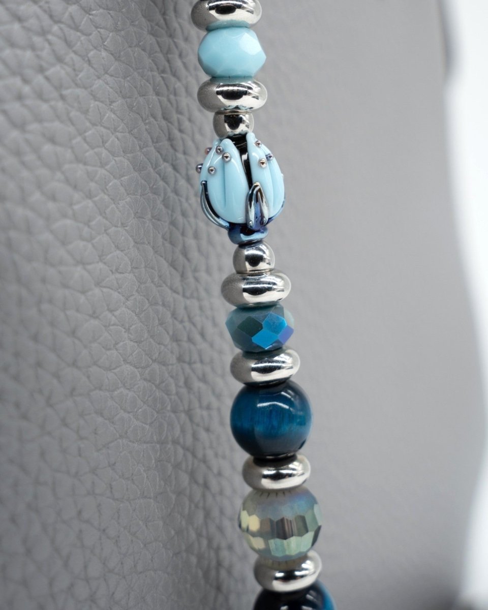 LD Keyfinder Whispering Garden beaded accessory featuring a handcrafted blue glass tulip and blue tiger eye beads.
