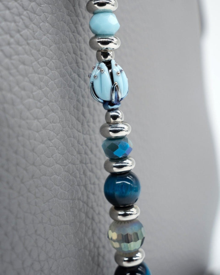LD Keyfinder Whispering Garden beaded accessory featuring a handcrafted blue glass tulip and blue tiger eye beads.