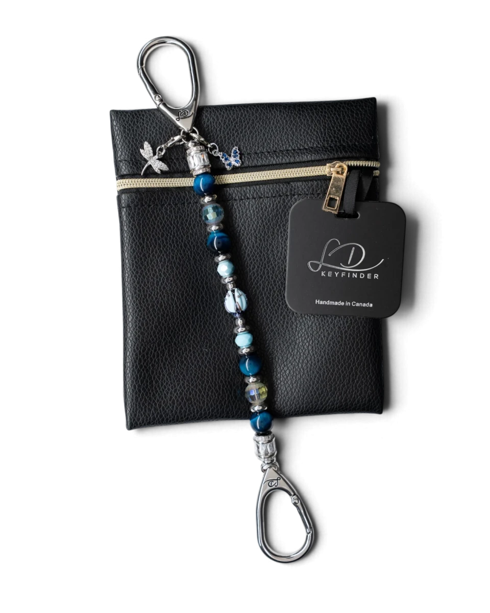 LD Keyfinder Whispering Garden beaded keychain with blue tiger eye, glass tulip, and dragonfly charm on a leather pouch.