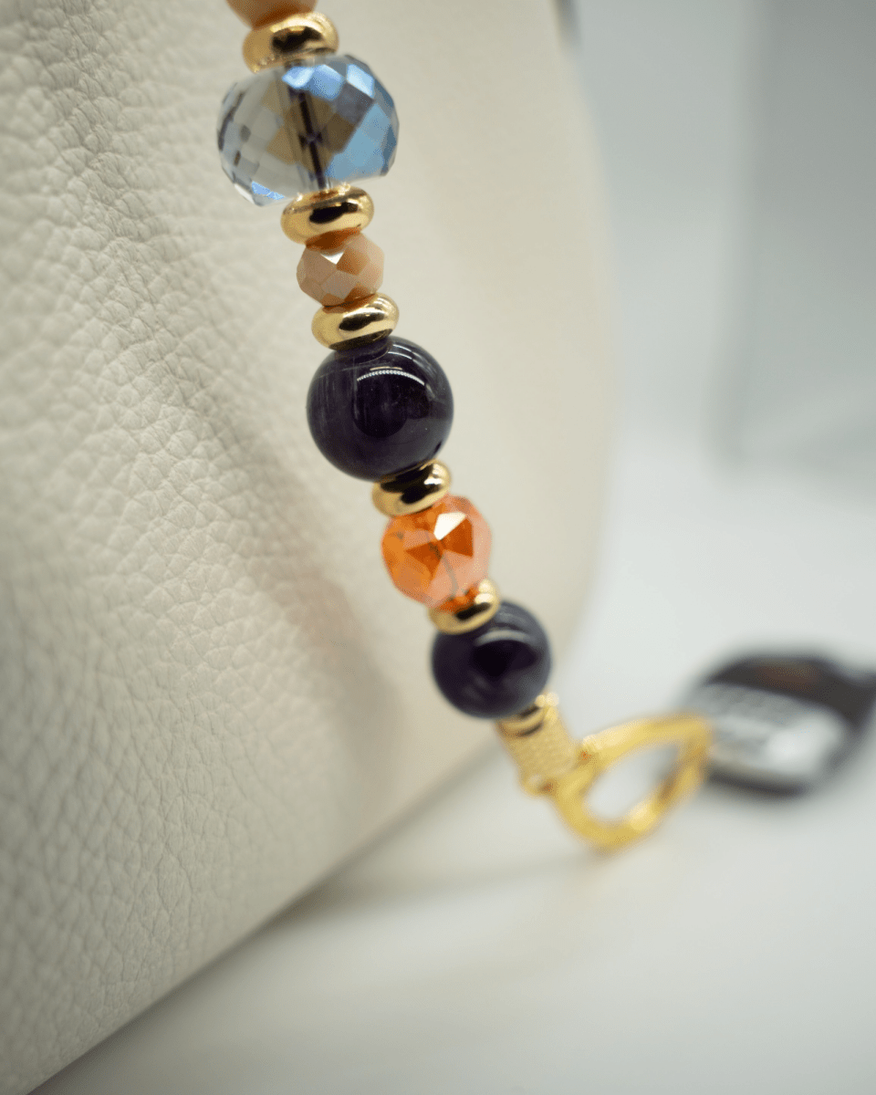 LD Keyfinder Whoo's There beaded accessory featuring amethyst, orange, and indigo crystals with 18KT gold-plated beads.