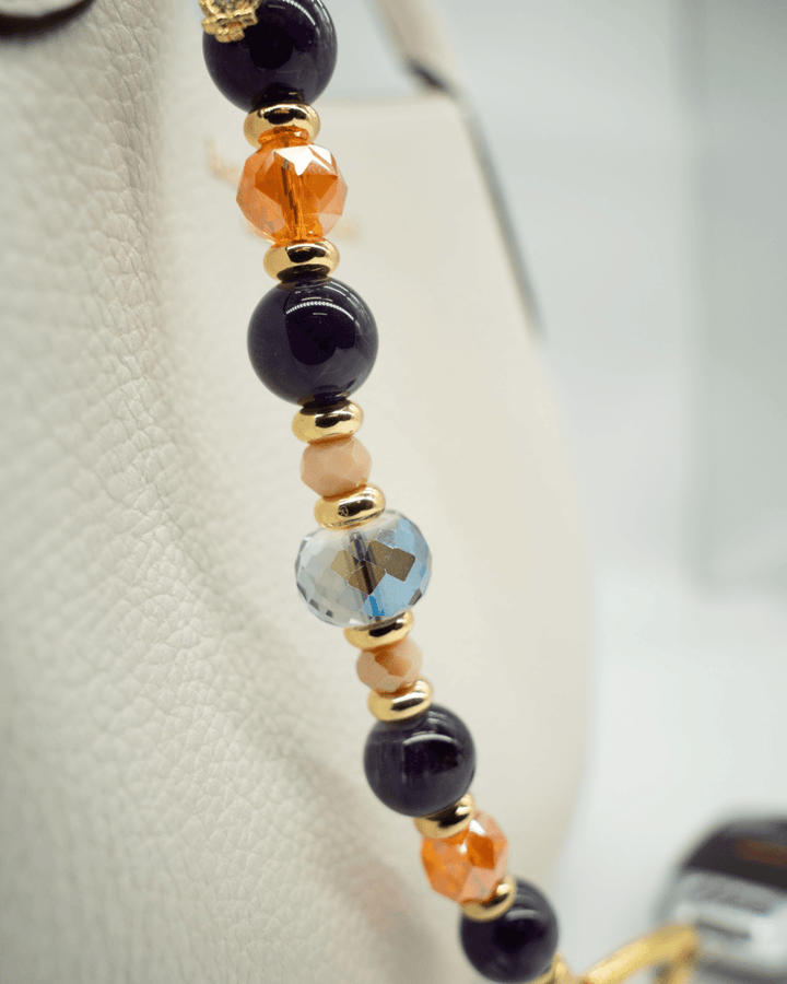 LD Keyfinder Whoo's There beaded accessory with amethyst, orange, peach, and indigo crystals and a gold owl charm.