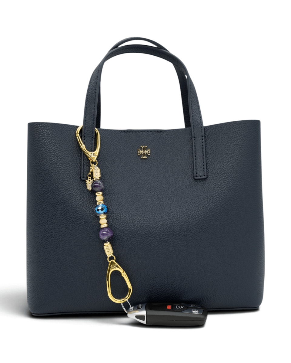 LD Keyfinder Whoo's There-Mini featuring amethyst, peach jade, and indigo crystal beads with a gold owl charm on a bag