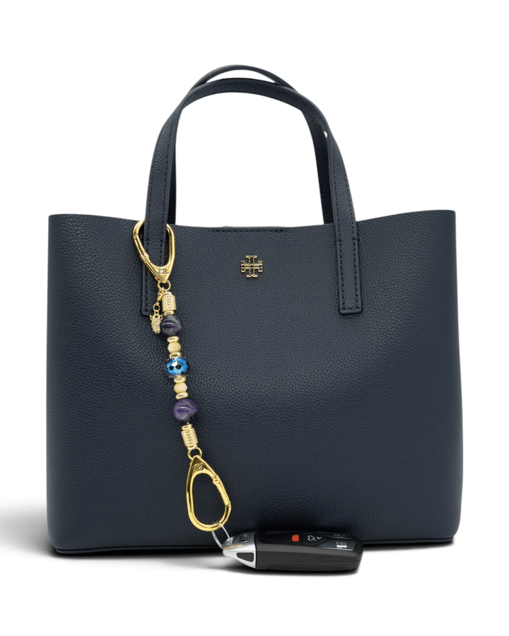 LD Keyfinder Whoo's There-Mini featuring amethyst, peach jade, and indigo crystal beads with a gold owl charm on a bag