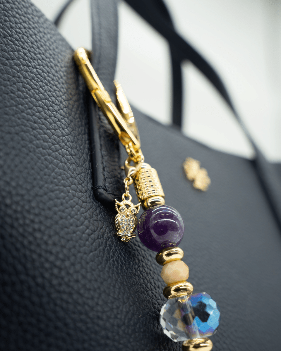 LD Keyfinder Whoo's There-Mini featuring amethyst, peach jade, and indigo crystal beads with a gold owl charm on a bag