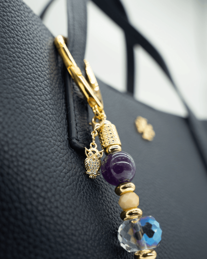 LD Keyfinder Whoo's There-Mini featuring amethyst, peach jade, and indigo crystal beads with a gold owl charm on a bag