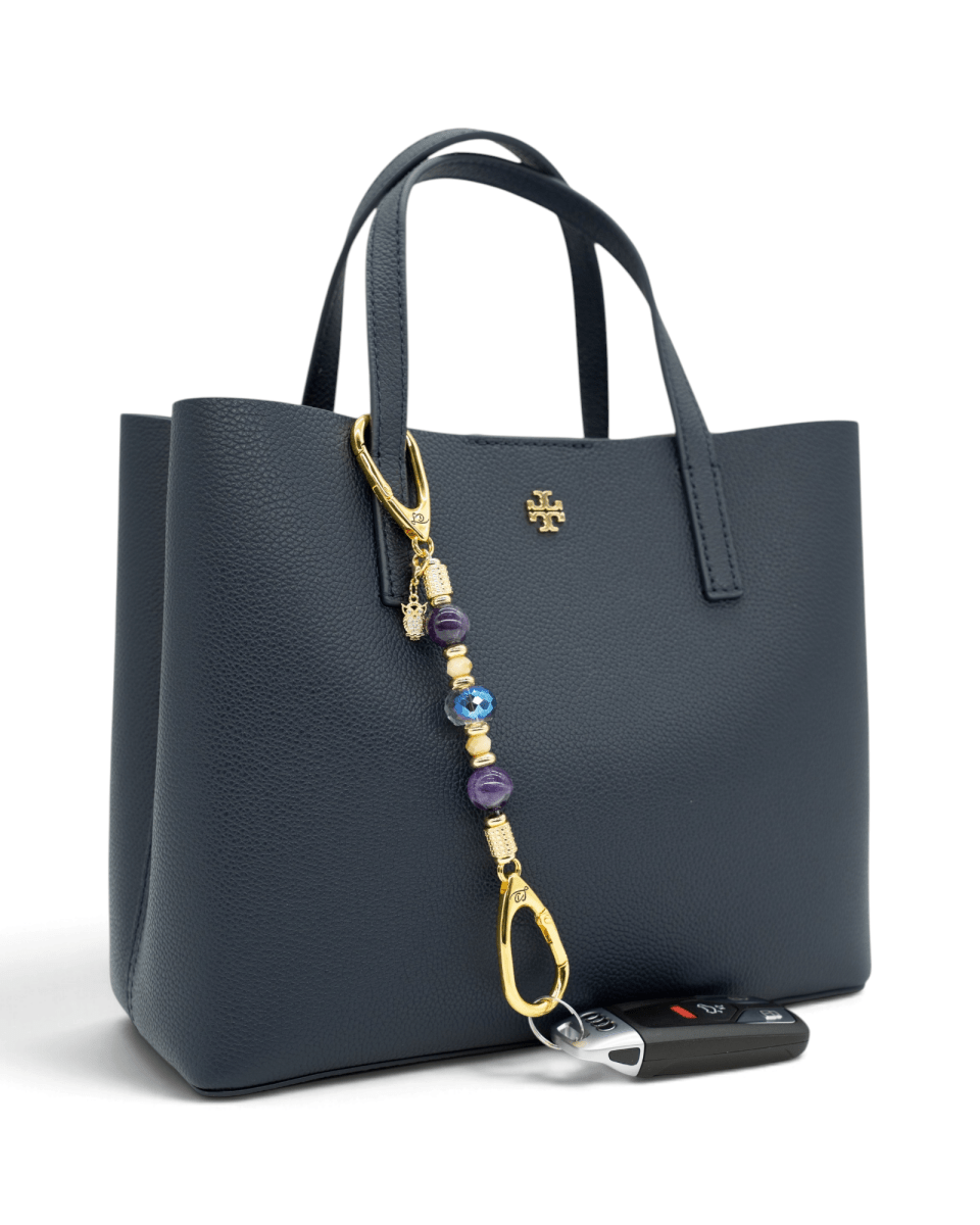 LD Keyfinder Whoo's There-Mini featuring amethyst, peach jade, and indigo crystal beads with a gold owl charm on a bag