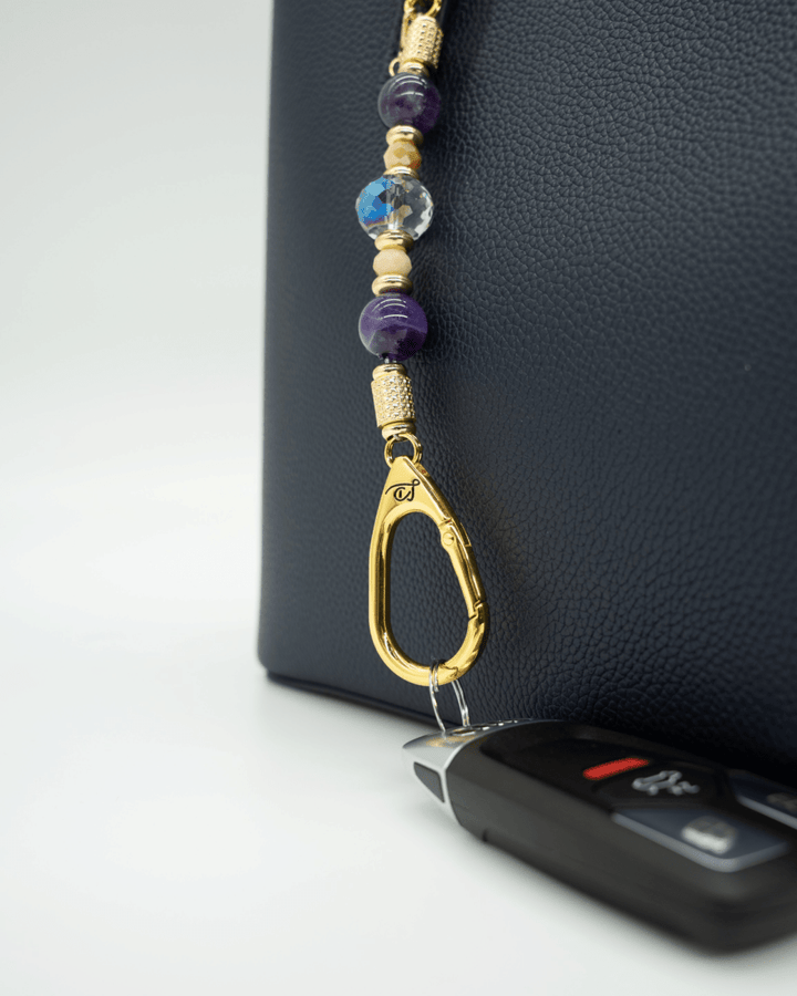 LD Keyfinder Whoo's There-Mini featuring amethyst, peach jade, and indigo crystal beads with a gold owl charm.