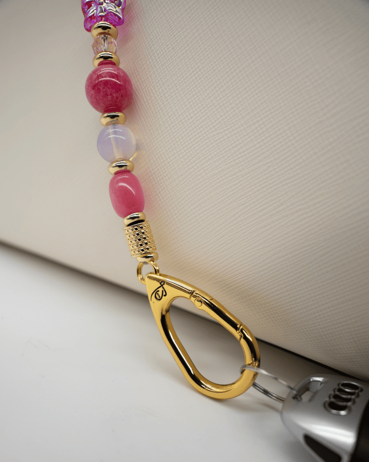 LD Keyfinder Wings of Hope beaded keychain with pink gemstones, gold-plated hardware, and a butterfly charm.