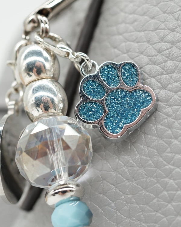 Sparkling teal dog paw charm