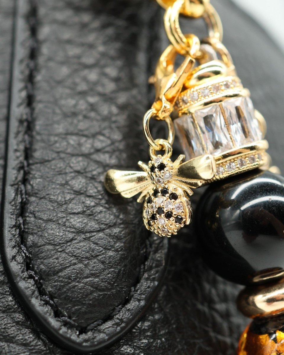 LD Keyfinder Queen Bee II charm with black obsidian, gold accents, and a bumblebee charm with black and white crystals.