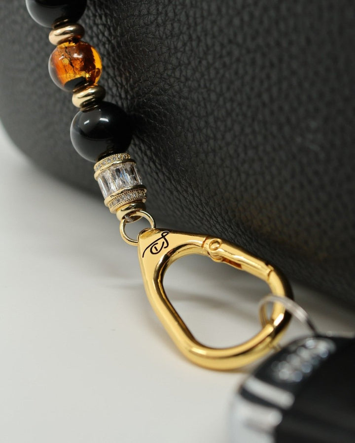 LD Keyfinder Queen Bee II lanyard with black obsidian, amber, and crystal daisy beads, gold accents, and bumblebee charm.